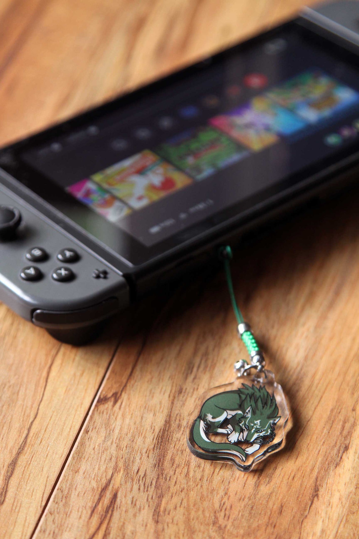 Nintendo switch with Wolf Link phone strap attached.